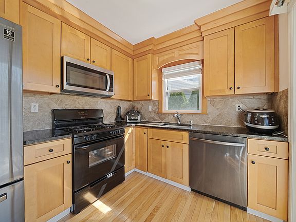 SLIDING DOORS TO SPACIOUS DECK AND BACK YARD