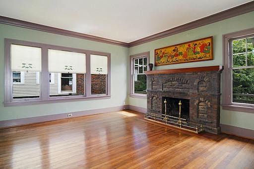 Enter the Bungalow and enjoy the period fireplace and many windows in the living room