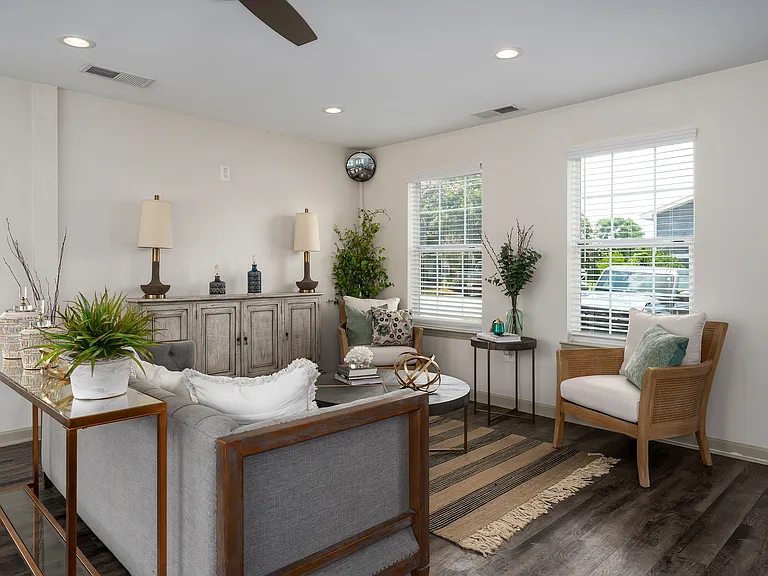 Relax in our inviting community room featuring comfortable furnishings and ceiling fan, professionally operated by Highlands Vista Group.