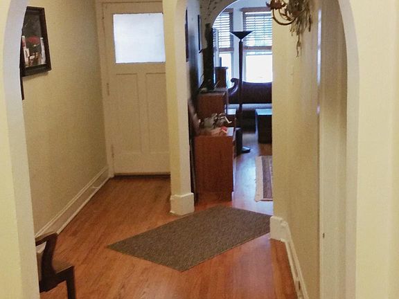 Front entrance hallway looking into living room.