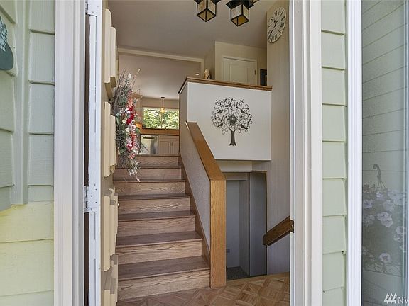 Gleaming hardwood floors greet you at the entry and run up the stairs and into the kitchen and dining room.