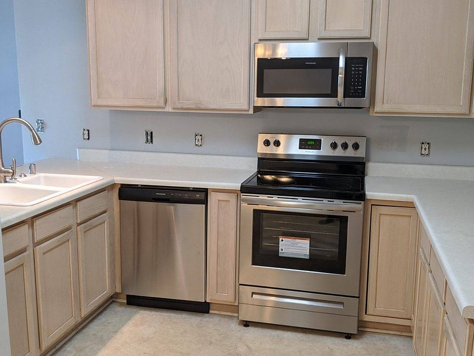Kitchen with newer stainless steel appliances and quartz countertops.