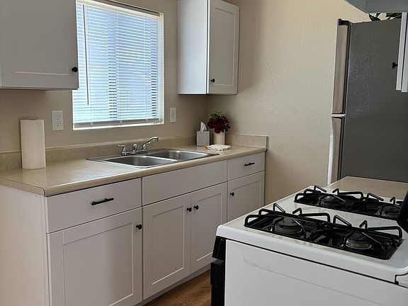 Welcome to your kitchen! New cabinets, new flooring throughout. Full size refrigerator, gas stove/range.