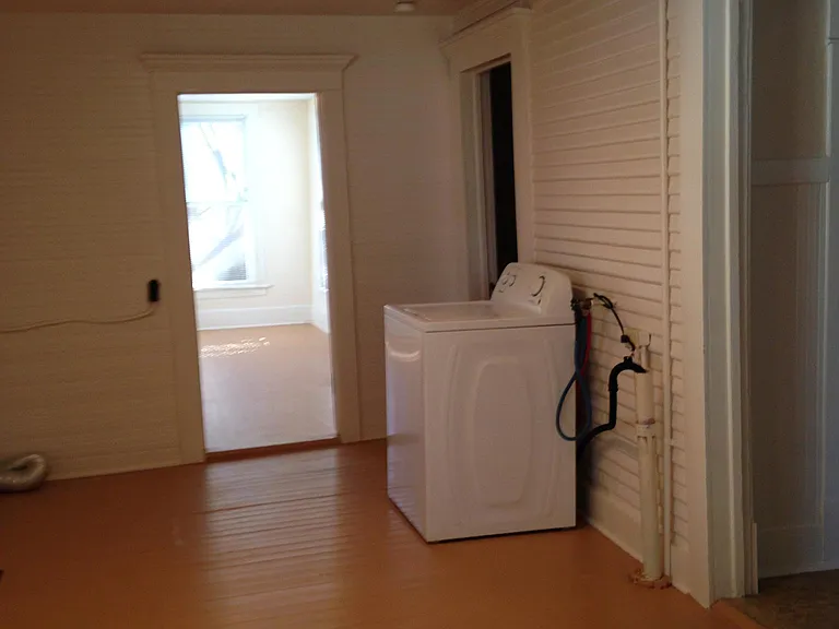 Partial view of laundry room with newer washer. Dryer hook up and venting. are provided. Hardwood flooring throughout home. Track lighting offers full view even on cloudy days or evenings.