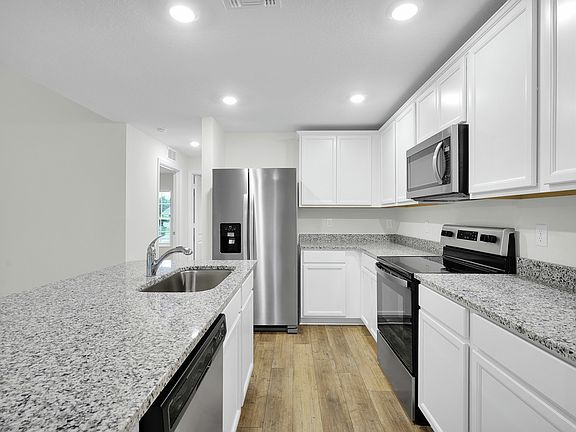The kitchen is chef-ready with stainless steel appliances