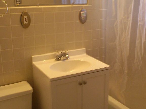 Fresh, clean tiled full Bath, New cabinets, flooring, and de