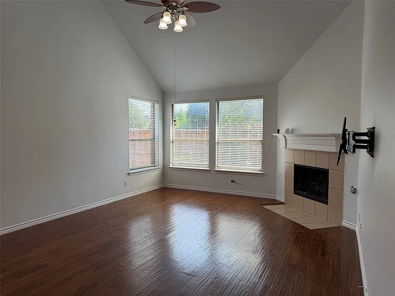 Living room with soaring ceilings and cozy fireplace.