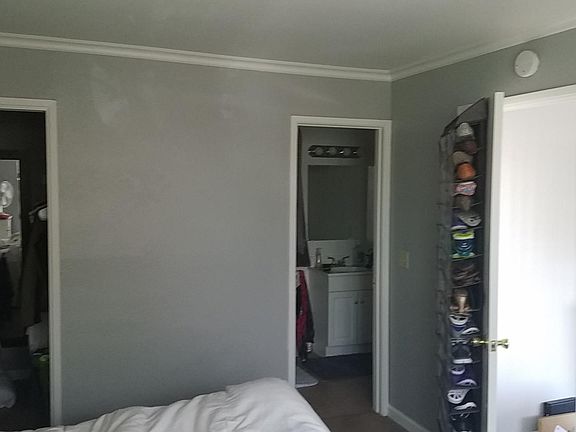 Bedroom facing closet and bathroom