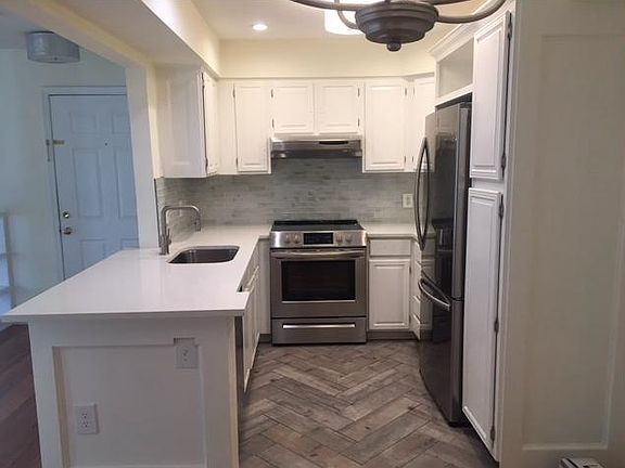 New appliances including microwave, quartz counters and spacious refrigerator