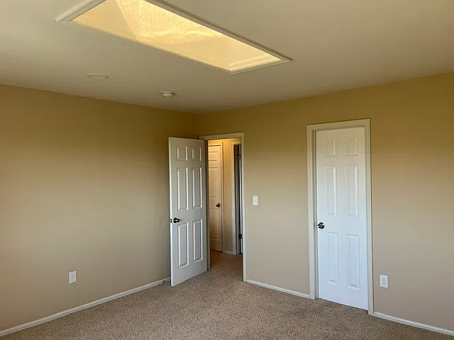 UPSAIRS PRIMARY BEDROOM WITH SKYLIGHTS.