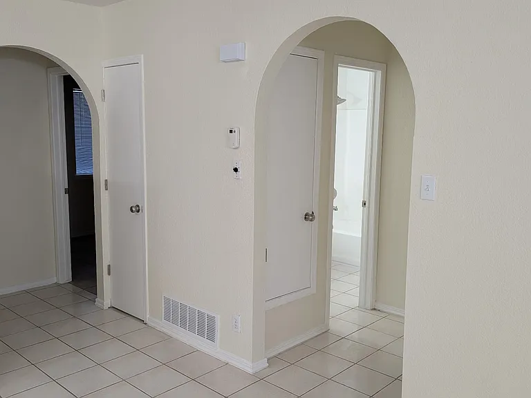 Open doorways leading to the bathroom, main bedroom, 2nd and 3rd bedrooms.