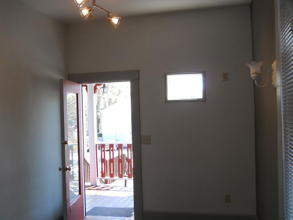 2nd. floor Rear Door exiting the Den onto Roofed Porch accessing rear staircase to private Parking Lot.