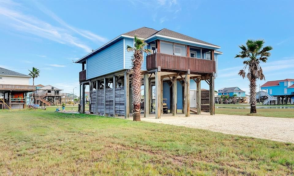 This 3/2 beach home features 2 porches, a golf cart garage and open concept living area.