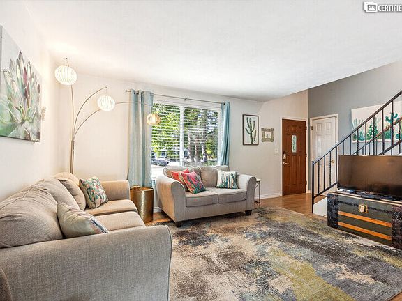 Living room, full-size couch, love seat, smart TV, entrance
