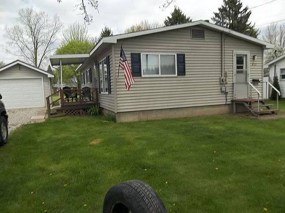 Vinyl sided house with dark blue shutters