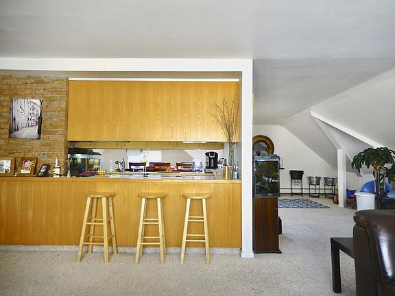 Kitchen opens to both living room and dining room areas with plentiful cabinets that open on both sides.