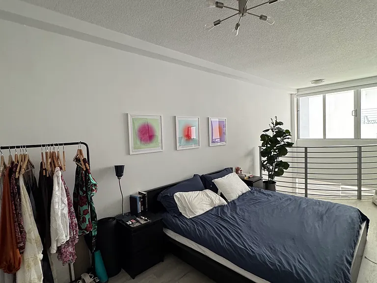 Bedroom - Spacious loft-style bedroom with high ceilings and an open layout, offering plenty of room for a king-size bed, seating area, or home office setup. A serene retreat with endless layout possibilities.