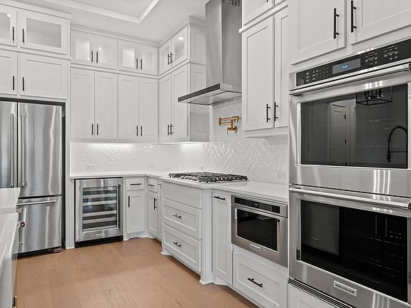 The kitchen has stainless-steel KitchenAid appliances.