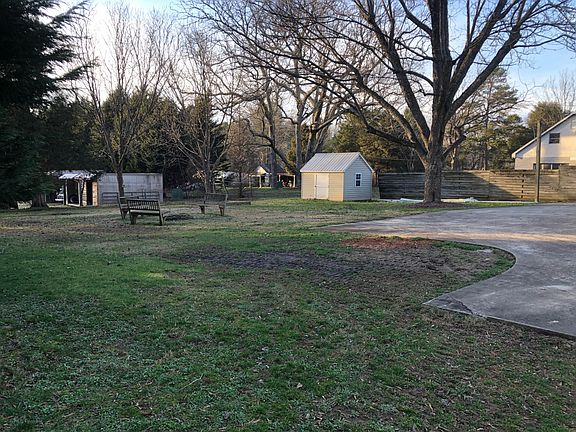 Backyard with Fire Pit and Storage Building