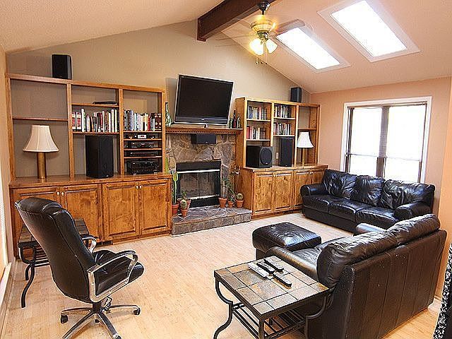 Build in Bookcases Surround the Stone Fireplace