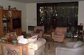 Living Room, with view out to private patio and built-in air conditioner