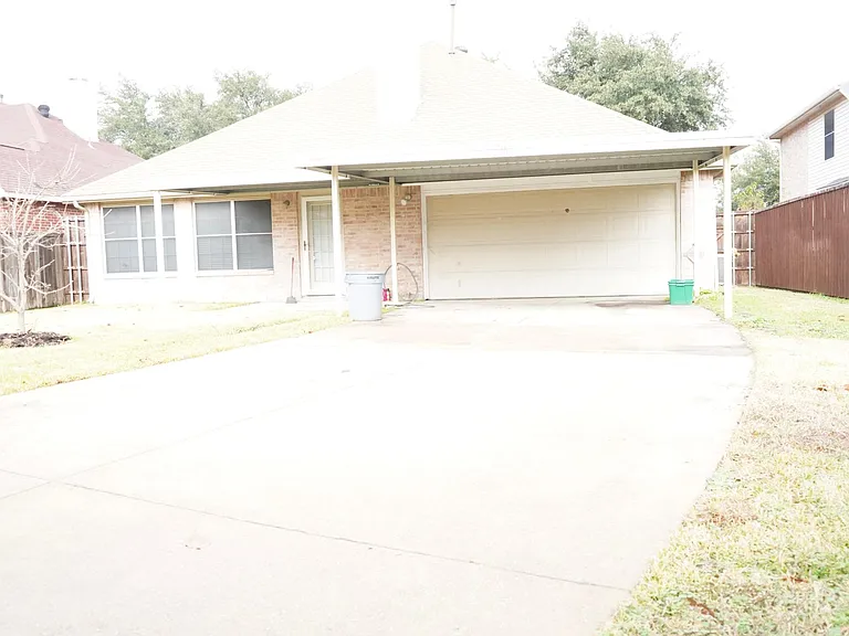 Backyard with 2 car garage and an additional 2 car carport.