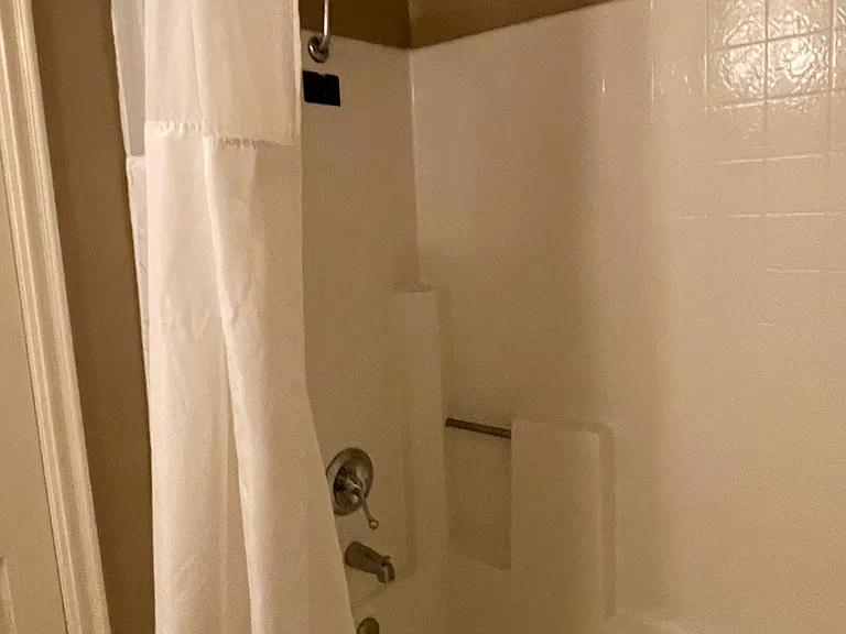 Second bathroom with jack & jill doors, a full bathtub, and a bidet smart toilet.