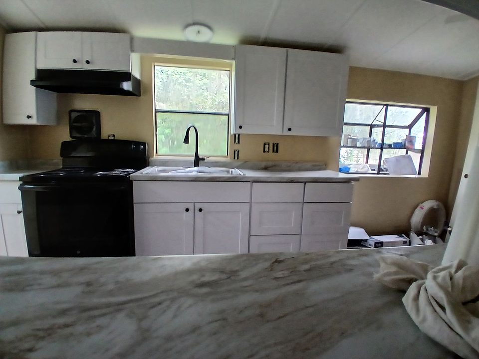 Kitchen view from the living room, new cabinets, counters and sink.