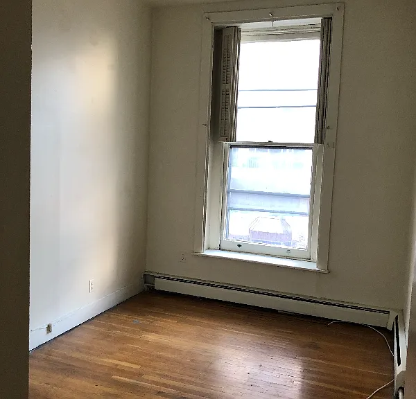 Light-filled second bedroom with ample storage space.