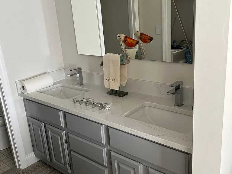 Vanity off of twin edroom with new fixtures and quartz vanity top.