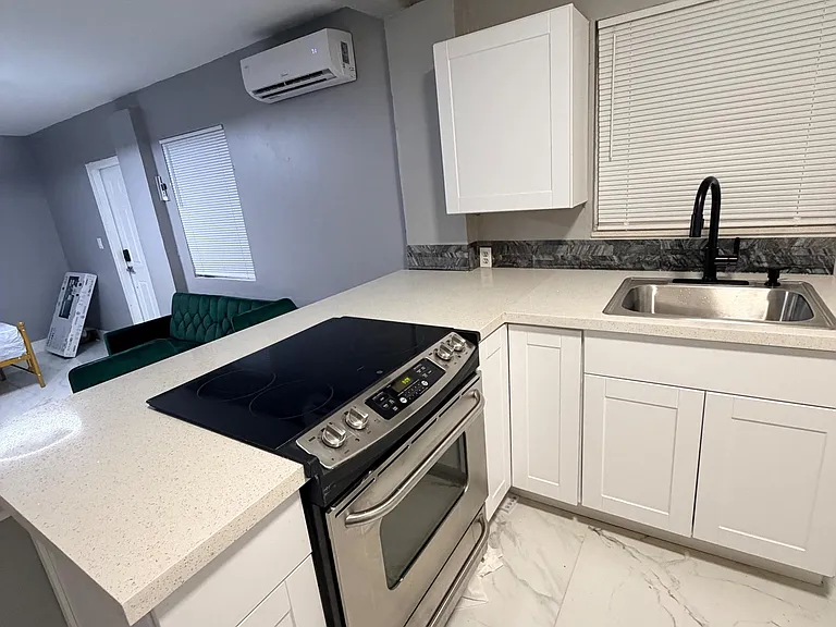 Updated kitchen with shaker cabinetry, generous counters, and a stainless range plus deep sink for easy meal prep.