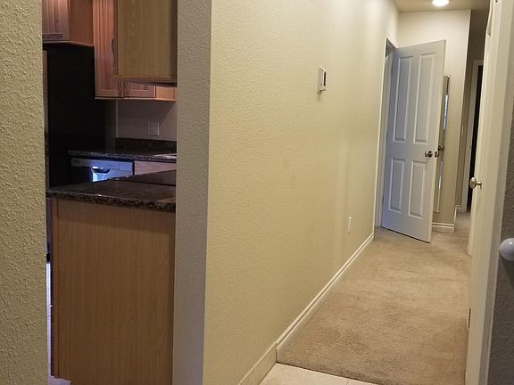 Hallway to 2nd bedroom, full guest bath, master suite, and laundry closet.