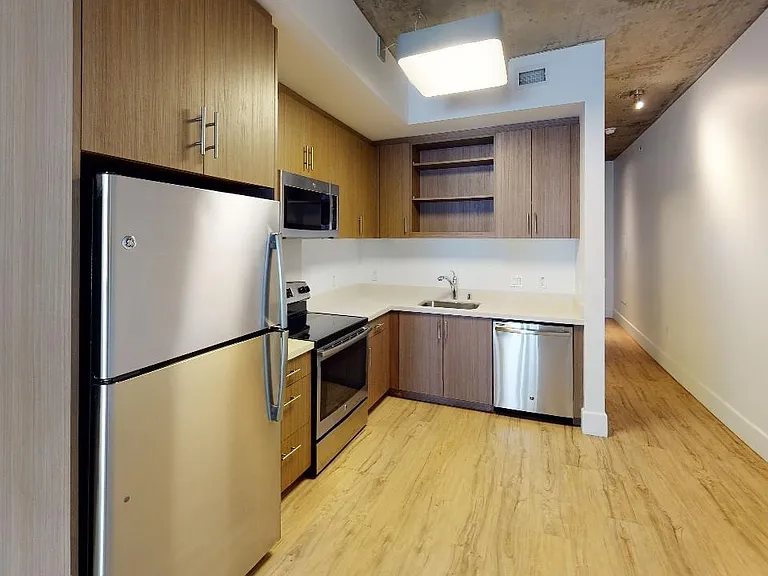 Stylish kitchen with stainless steel appliances and quartz countertops