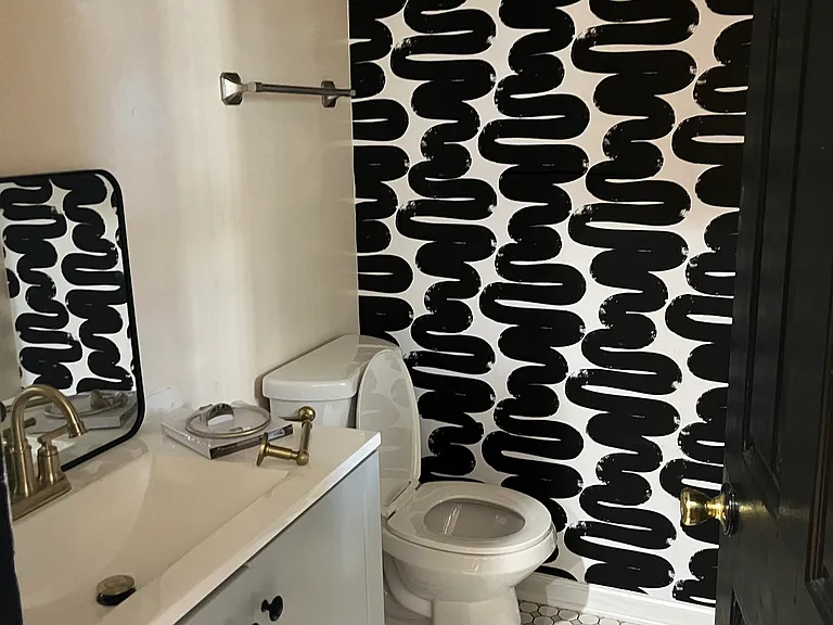Downstairs has a powder room for guests right off the kitchen right next to a first floor laundry room! A win for homes in this area.