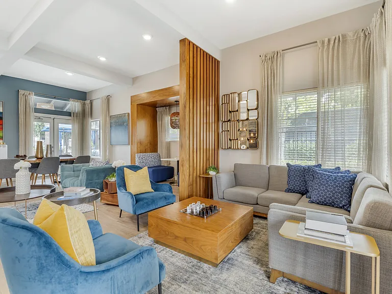The clubhouse offers a variety of seating options and is filled with natural light, creating a bright, inviting space for residents to relax, work, or connect with neighbors.