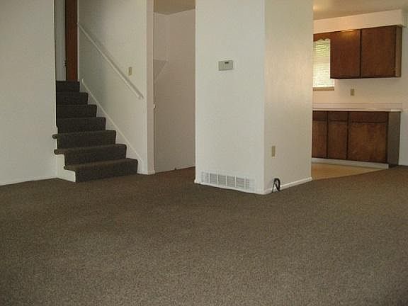 Living, kitchen and stairs, showing previous carpet