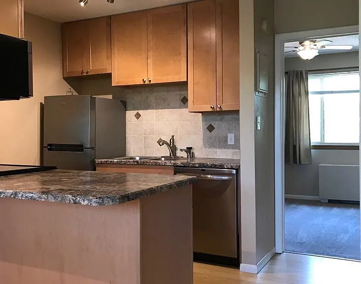 Kitchen + bedroom in background