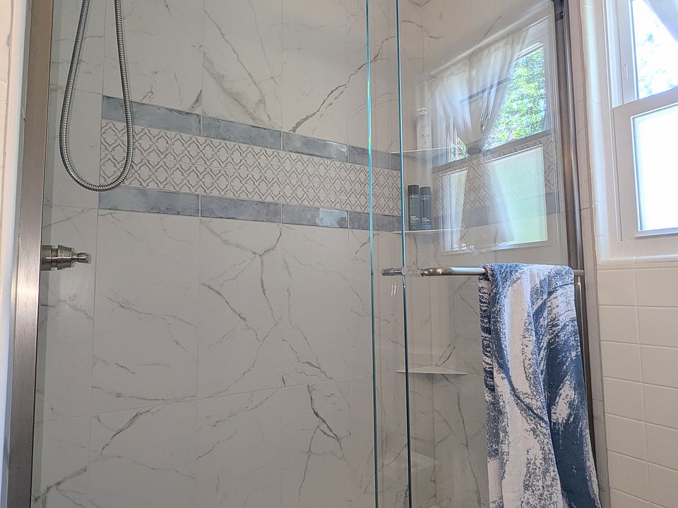 Porcelain Tile shower w glass doors upstairs.