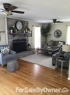 Family room has a wood burning fireplace and hardwood floors.