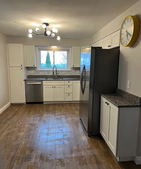 Kitchen with brand new appliances, updated flooring and new light fixtures.