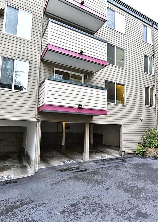 Carport directly under balcony.