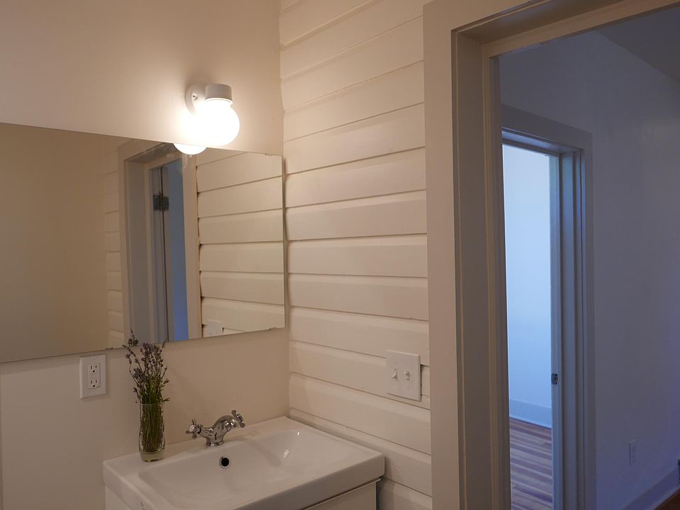 Bathroom. Wall - original building siding. Under-the sink vanity cabinet for storage.