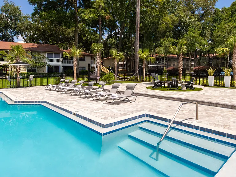 Another angle of our spacious sundeck, showcasing a variety of seating options, from sun loungers to hammocks.