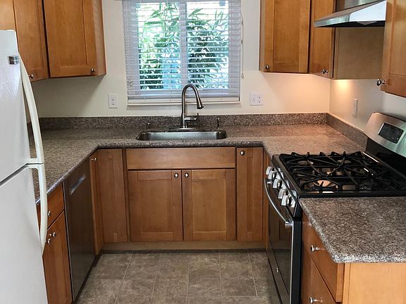 Remodeled Kitchen, gas stove, dishwasher, view to front yard, attached garage to the right.