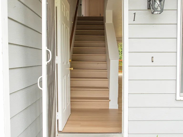 Covered front entry with direct access to the main living areas and staircase leading to the second floor bedrooms and full bathroom.