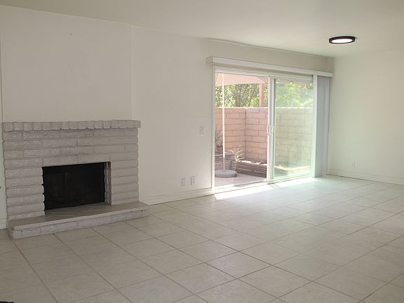 Open living space with gas fireplace and two outdoor spaces