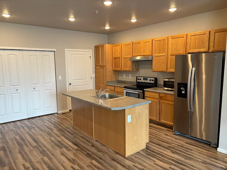Beautiful simulated wood floors in pristine condition. Easy access to washer and dryer (next photo)