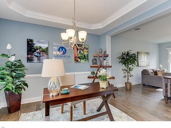 Dining Room shown comes with trey ceiling, chair rail and hardwood. Photo shown similar to home being built.