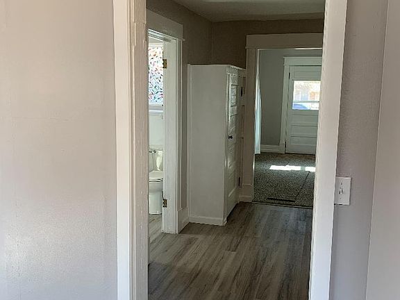 from Bedroom, looking into kitchen and living room, bathroom is off to the left