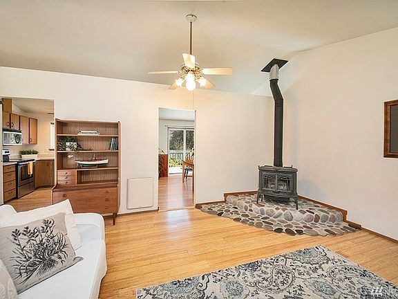 Photographers back is to the front windows, to the right you can catch a glimpse of the dining area and upper deck beyond.  To the left you can see part of the spacious kitchen. 